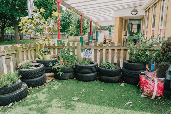 Photo of an outdoor garden that uses tires as plant holders